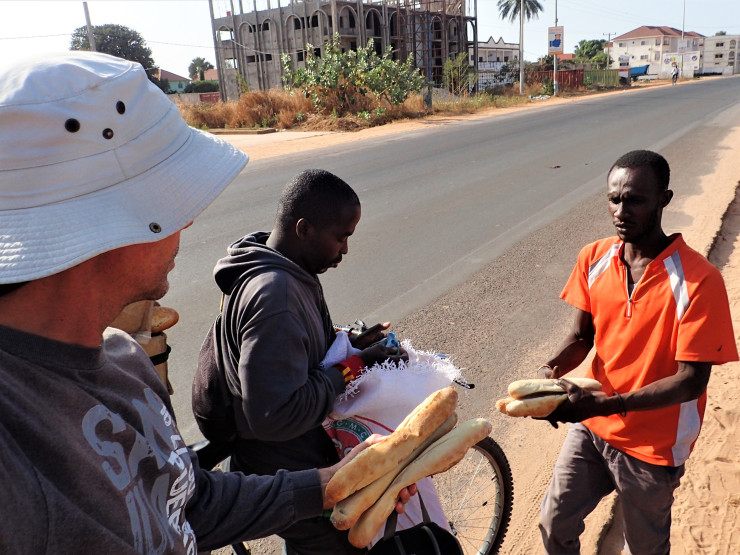 Scoring fresh bread after three days of a complete shutdown, state of emergency in Brusubi, Gambia