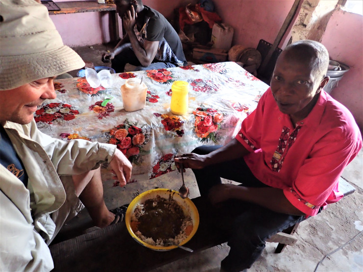 Sharing a bowl of goat meat and couscous with pastor Solomon in Bafata, Guniea-Bissau