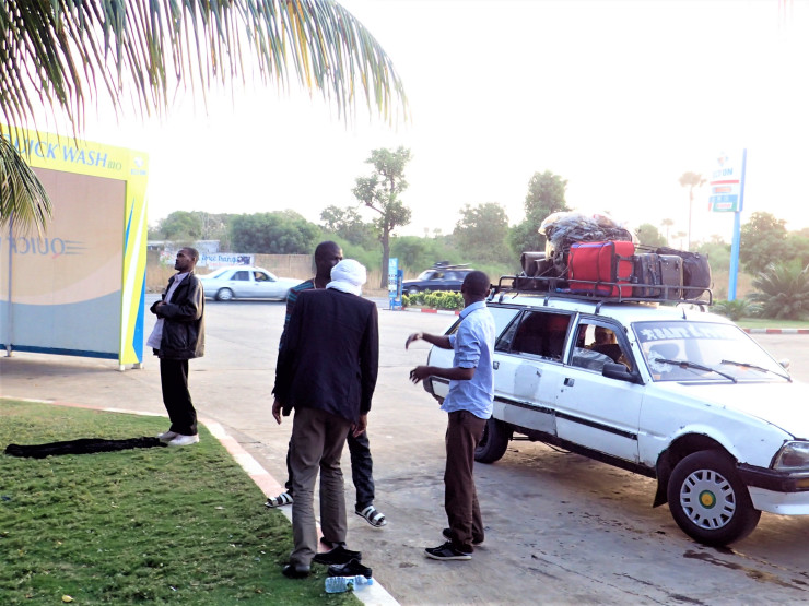 Stopping to pray before sunset while traveling from Rosso to Dakar, Senegal